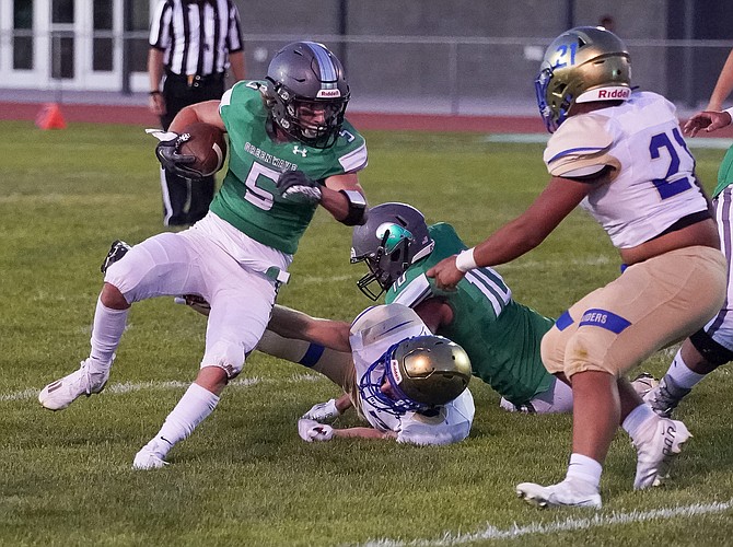 Fallon running back Roland Grondin cuts to the middle for a first down in Friday’s season opener against Reed.