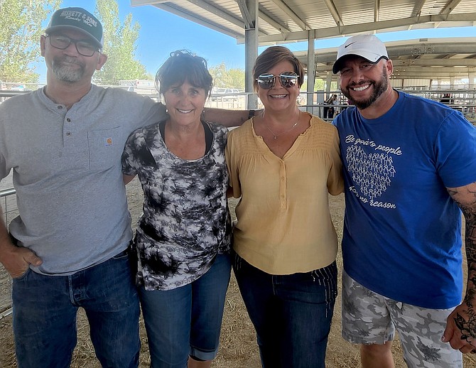 Community and Oasis Academy staff members who puckered up to kiss the pig on Sunday were, from left, winner Steve Hiskett, Sue Frey, Heidi Hockenberry-Grimes and Andy Lenon.