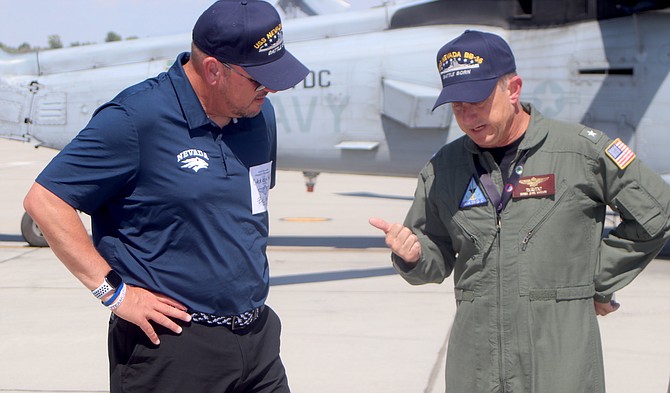 Nevada football coach Ken Wilson, left, and Naval Air Warfighting Development Center commander Rear Admiral Max McCoy talk about the Navy’s role in the desert.