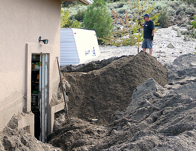 The Brauns dig out their house with the help of their neighbors.