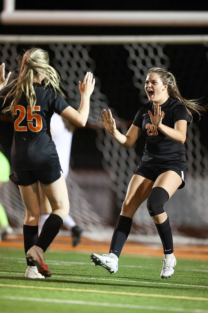 Douglas High’s Aleeah Weaver, right, celebrates one of her three goals against Spanish Springs on Thursday night. Weaver’s hat trick helped lead the Tigers to a 5-0 win.