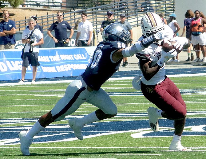 Bentlee Sanders (20) of Nevada reaches out to stop Texas State’s Rontavius Groves on Sept. 3, 2022 at Mackay Stadium.