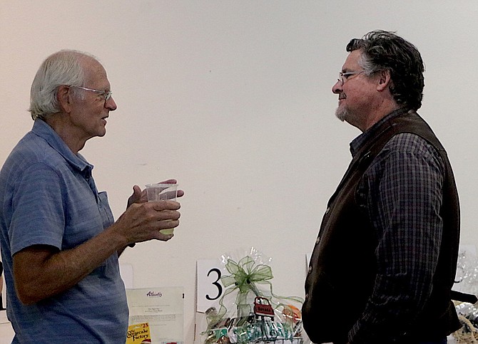 Marc Reynolds, left, talks to new museum Director Mel Glover.