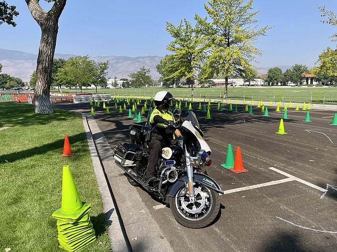 Carson City Sheriff’s Deputy Jessica Dickey, a motor officer, prepares for a sharp turn on the training course at Mills Park during the annual Motor Officer Training Challenge on Thursday.