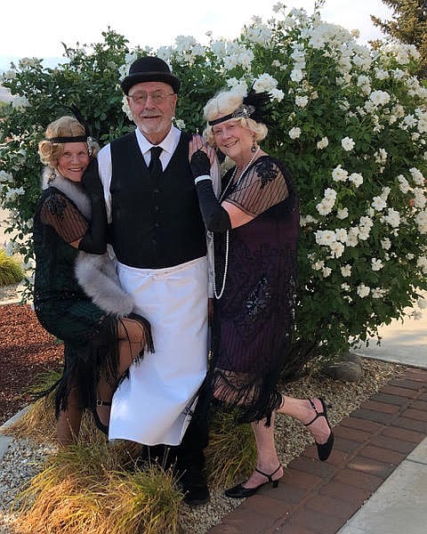 Friends’ members Kathy Pierson and Anne Oakes cozy up to bartender Don Oakes before the Silver State Speakeasy opens.