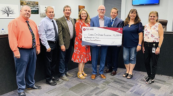 Carson City School Board members and Superintendent Andrew Feuling accept a donation from Southwest Gas. Trustees Mike Walker, left, Trustee Richard Varner, Trustee Joe Cacioppo, Trustee Laurel Crossman and Stacie Wilke-McCulloch, second from left, stand with Brad Harris, vice president of Northern Nevada and California, center, and Stacy Woodbury, manager of Public Affairs, for Southwest Gas, far right.