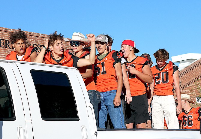 Members of the Douglas Tigers football team ride under blue skies in Minden on Wednesday evening.