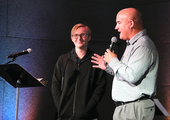 Patrick Maynard, Sierra Lutheran High School’s head of school, recognizes student Hayden Steyn for qualifying for the National Merit Scholarship program Wednesday during the campus’ weekly chapel service.