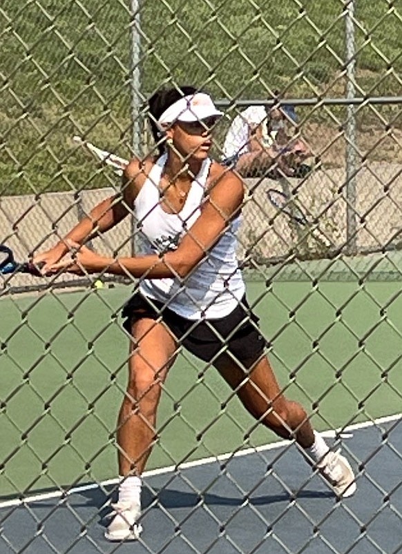 Douglas High’s Joscelyn Turner sets up to hit a backhand against McQueen on Wednesday. The Tigers’ contest with the Lancers ended early in a 3-3 draw due to air quality.