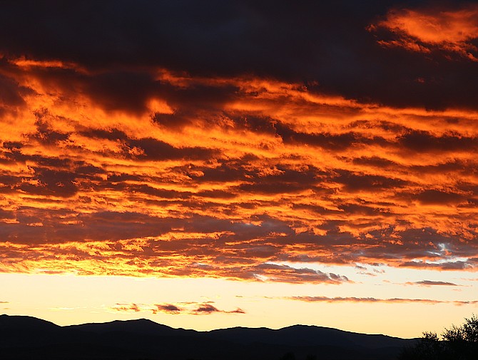Sunrise set the clouds ablaze over the Pine Nut Mountains from Genoa on Tuesday morning.