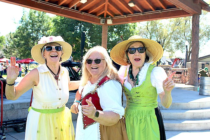 Elisabeth Olesen, Sertoma’s Birgit Okamoto and Marilyn Bollinger are dressed for Oktoberfest on Saturday in Gardnerville’s Heritage Park.