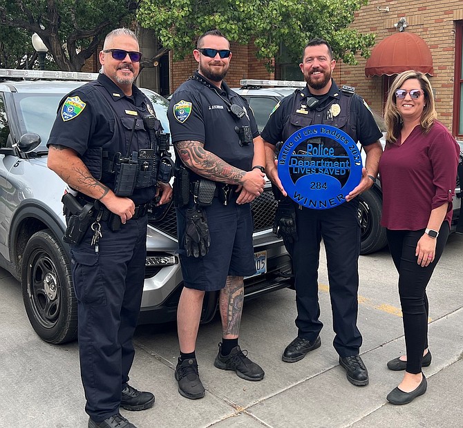 The winning team in the Battle of the Badges. From left are Mike Woolf, Josh Atchison and Jose Perez. One of the organizers is Shannon Perez, right.