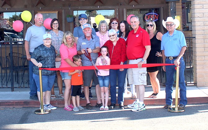 New owner Barry Vasquez, with scissors, and the Fallon Chamber of Commerce recently conducted a ribbon cutting. Barry and Jennifer Vasquez recently purchased Pizza Barn from Roger Diedrichsen, who retired after operating the “Best of Fallon” business since 1978.