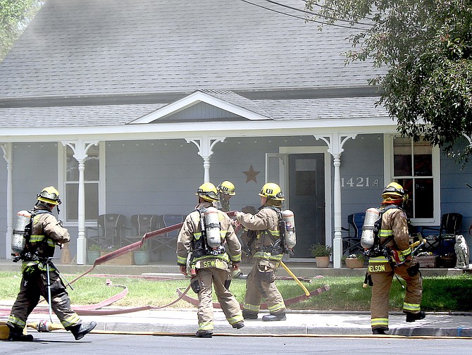 East Fork Firefighters wear self-contained breathing apparatus at a June 19, 2020, structure fire on Mission Street in Gardnerville.