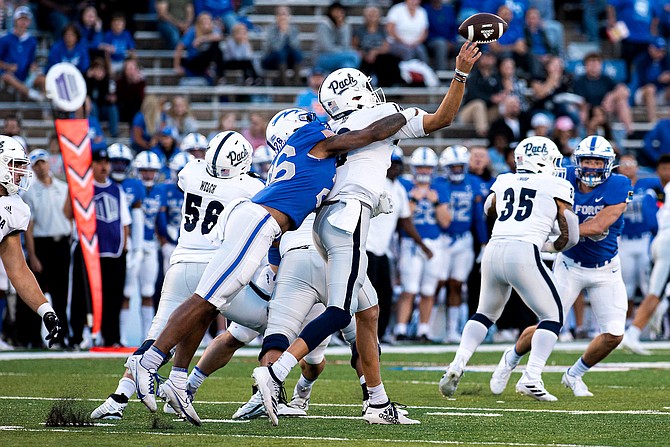 Nevada quarterback Nate Cox is hit by Air Force’s Vince Sanford during Saturday’s game in Colorado Springs.