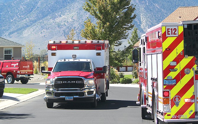 An East Fork ambulance carries two burn victims away from the scene of a truck explosion on Tuesday morning.