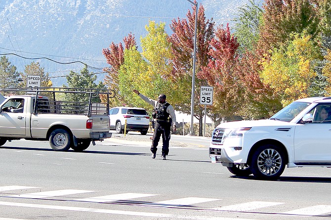 A Douglas County Sheriff's deputy directs traffic at highways 395 and 88 after a power outage affected a large swath of the western portion of the county.