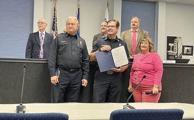 Carson City Fire Marshal Michael Wilkinson and Fire Chief Sean Slamon, with Mayor Lori Bagwell and supervisors in the background, discuss a proclamation on Oct. 6 recognizing Oct. 9-15 as Fire Prevention Week.