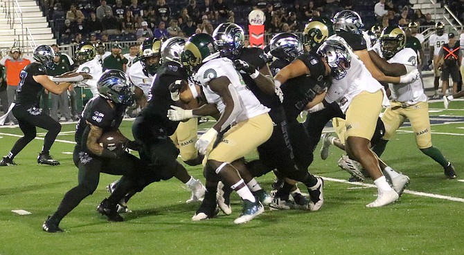 Wolf Pack running back Toa Taua (35, with ball) looks for some space against Colorado State on Friday.