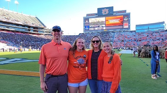 The Russell family stands on the sidelines at an Auburn University football game last weekend. Pictured from left to right are Tim Russell, Brynn Russell, Larkin Russell and Cassidy Russell.