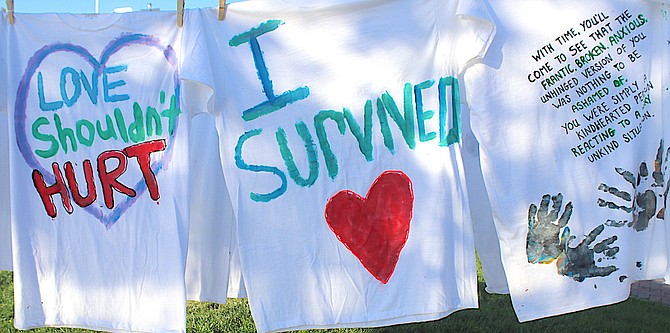The clothesline project at Millennium Park shows T-shirts with slogans written on them by domestic violence victims.
