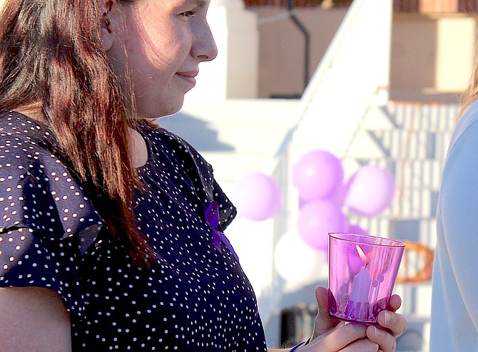 Taylor Deering holds a candle at last week’s candlelight vigil.