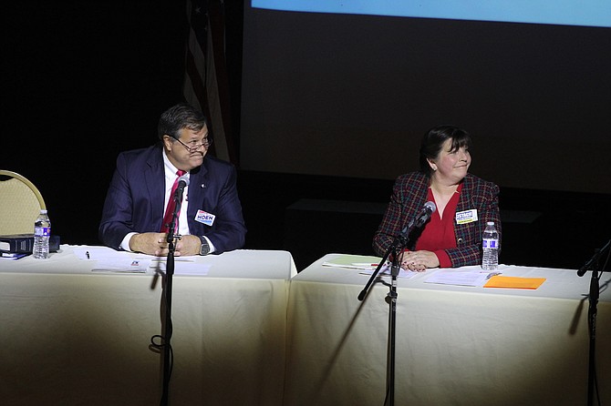 William Scott Hoen, left, and Stacie Wilke-McCulloch listen to moderator Anne Macquarie during the Carson City Clerk-Recorder candidate forum Oct. 17, 2022.