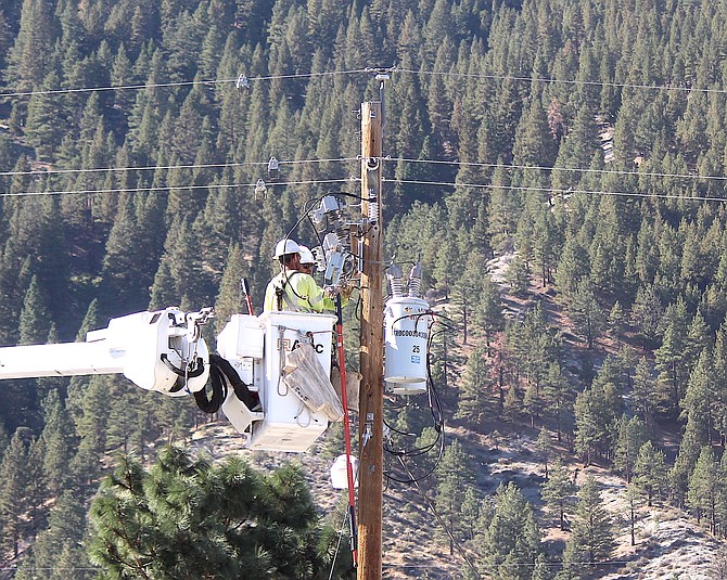 NV Energy contractors work on a pole in Genoa on Oct. 15.