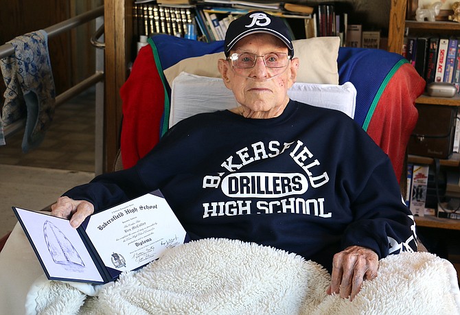 Carson City resident Ben McCulley, 91, a Navy veteran and retired general contractor, displays his high school diploma, sweatshirt and hat he received as a graduate from Bakersfield High School in California.