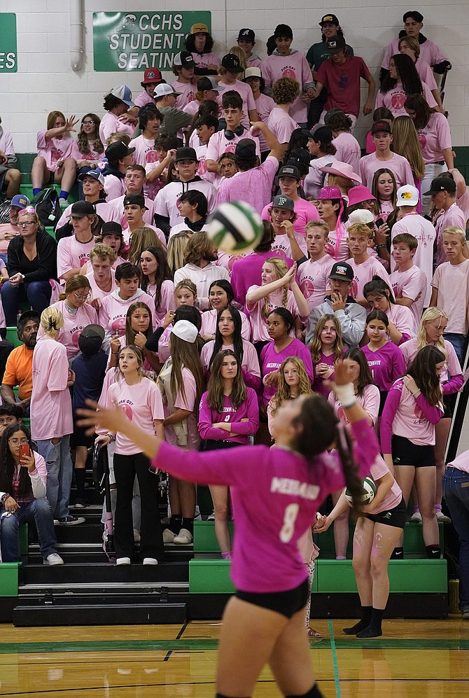 Students and other fans wear pink at last week’s Lady Wave volleyball game against Fernley to bring additional awareness to breast cancer. Jaqui Medrano is serving for the Lady Wave.