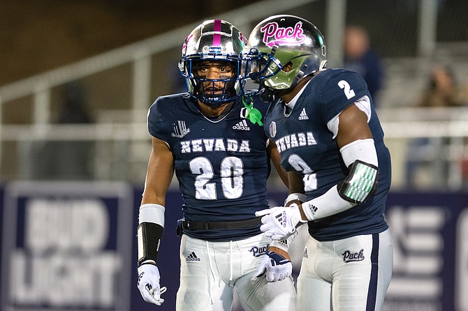 Nevada defensive back Bentley Sanders (20, with Isaiah Essissima) has emerged as one of the nation’s top defensive players this season.