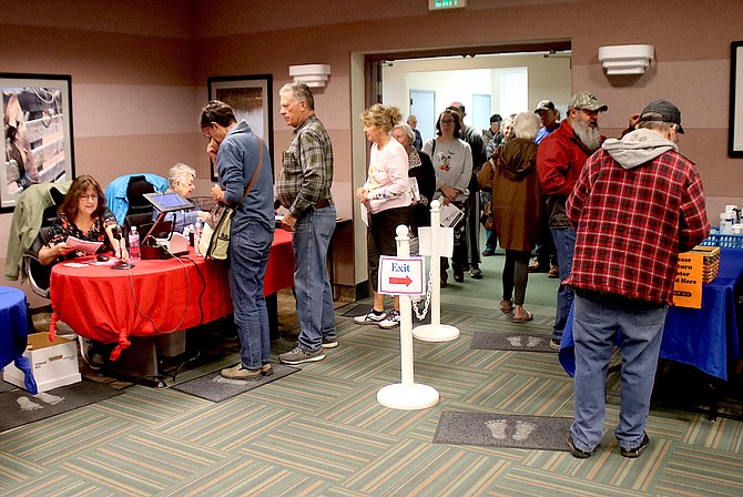 Voters pick up their ballots on the first day of early voting at the Churchill County Commission Chambers. Early voting ends on Nov. 4.