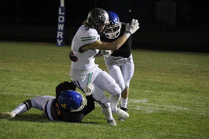 Fallon senior Tristan Hill wraps up a Lowry defender in Friday’s win over the Buckaroos.
