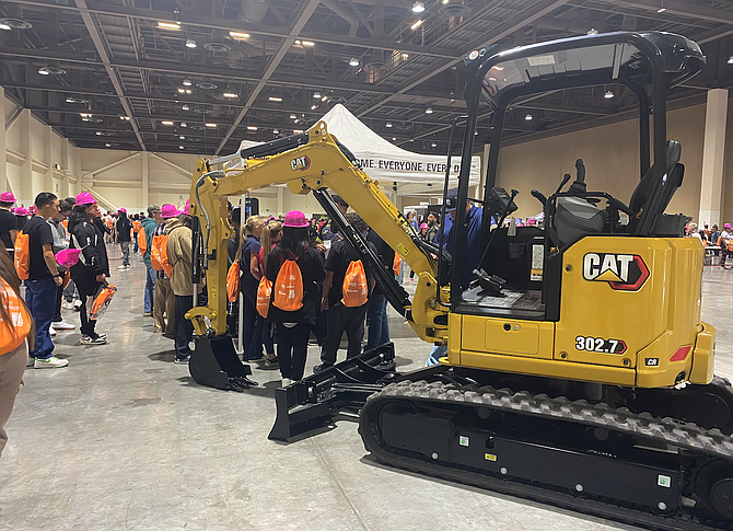 More than 1,600 students within the Washoe County School District donning hot pink construction hats are gathered in the space, visiting around 40 industry experts within the local building and skilled trade industry to learn about the various opportunities available to them after high school.