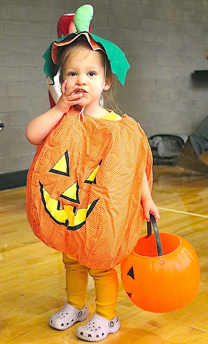 Two-year-old Clara Wilson waits in line to trick or treat at the Douglas County Community Center Thursday.