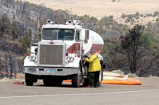 A firefighter breaks down a portable pond after the Numbers Fire in 2020. Without some other means, water tenders are often the only source of firefighting water away from hydranted areas.