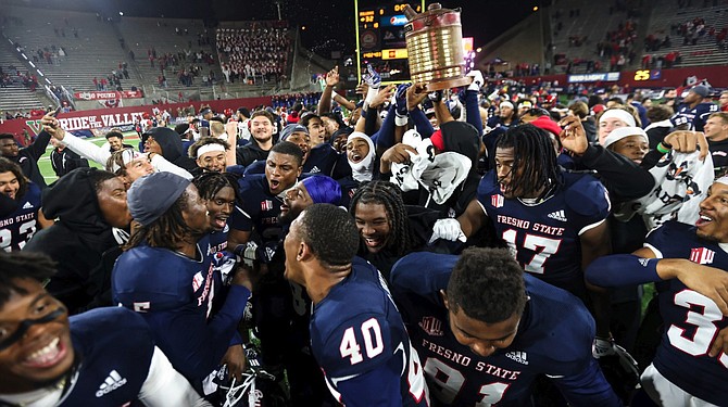 Fresno State football players celebrate after beating San Diego State on Oct. 29, 2022.