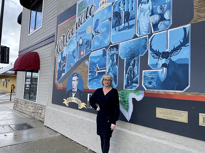 Carson City Arts and Culture Supervisor Sierra Scott in front of Abner Rivera’s public mural on North Carson Street on Nov. 2, 2022.