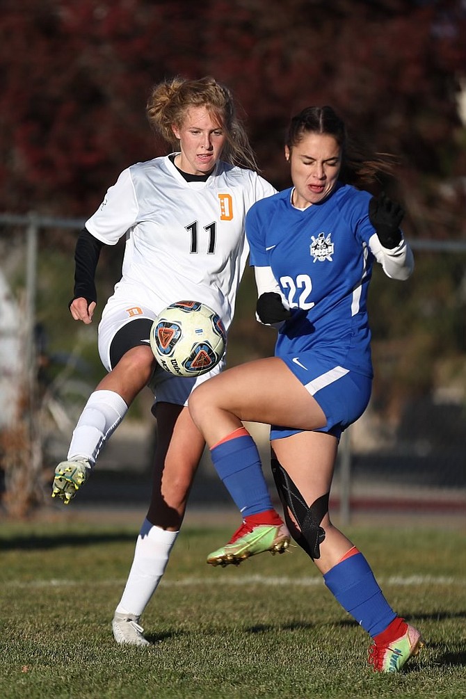 Kaylee Bradford (11) battles for possession for Douglas High girls soccer Wednesday. Bradford had the Tigers' lone goal in the Class 5A North regional semifinals.