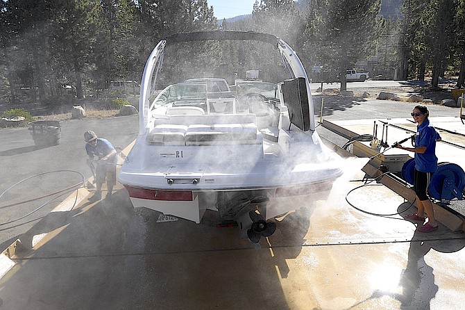 Boat inspectors decontaminate a visiting vessel at Lake Tahoe.