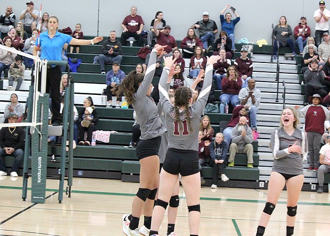 Dayton players celebrate a point during their three-game sweep of Elko on Saturday at Hug High School in Reno.