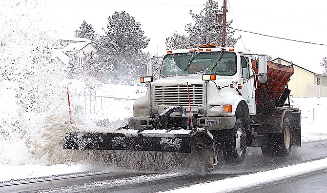 A Douglas County snowplow clears Jacks Valley Road on Tuesday afternoon after 6 inches of snow falls in Nevada's oldest settlement.