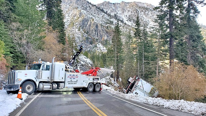 A Welcomes tow truck winches a semi back onto Highway 89 after it went over the side at Emerald Bay. CHP Photo