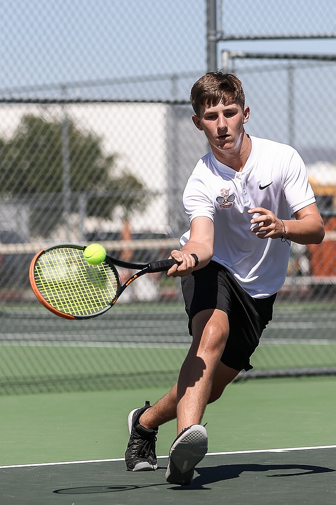 Douglas High’s Kolten Brown approaches to hit a forehand during a Tiger tennis match earlier this season. Brown was selected to the Class 5A North all-region tennis team as an honorable mention for his play this fall.