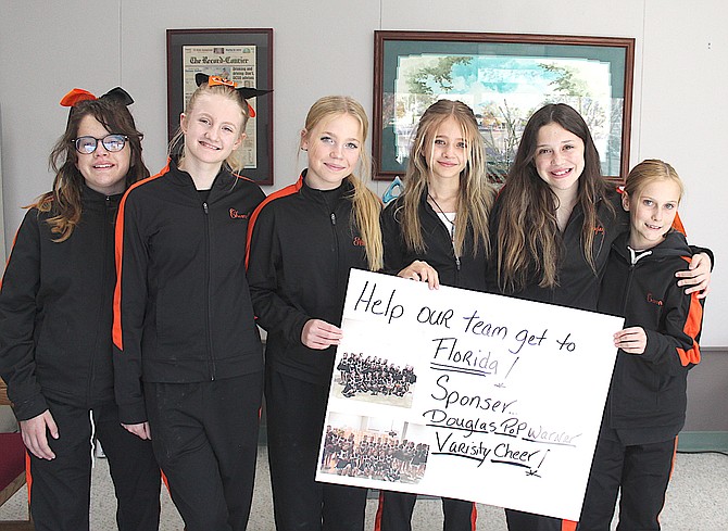 Members of the Douglas County Varsity Pop Warmer Cheer squad visited The Record-Courier on Thursday.