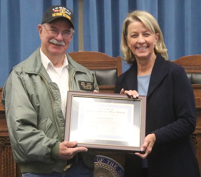 Outgoing Nevada Secretary of State Barbara Cegavske, right, honors Fallon Navy veteran Michael Terry as July’s Veteran of the Month.