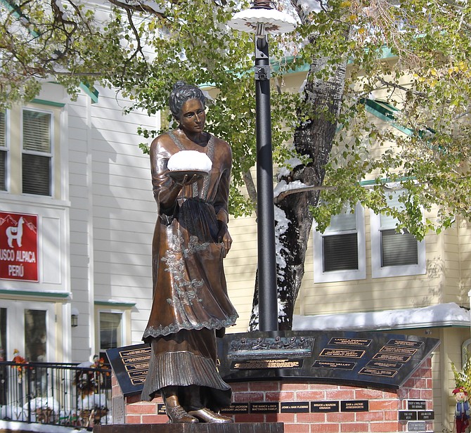 The Genoa statue of Lillian Virgin has a big plate of snow, looking like she's fixing to hurl it across Main Street at the statue of Snowshoe Thompson.