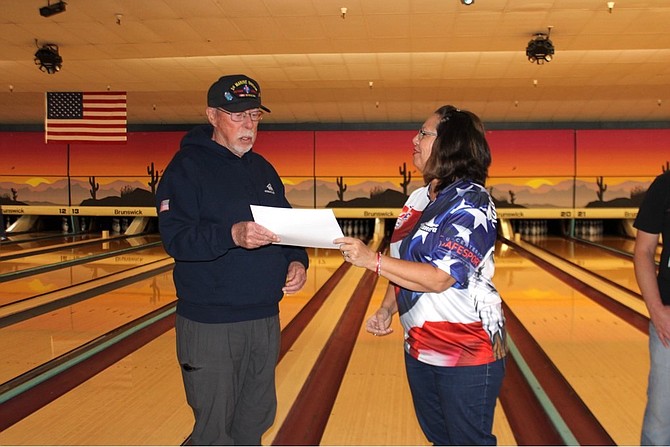 Local Bowlers for Veterans Link Committee Chair Sandra Hibler (right) presents a check for $5,970 to former board president Monk Mann of the Veterans Guest House in Reno. This check was for the funds raised during the 2021 efforts of the local bowling association.