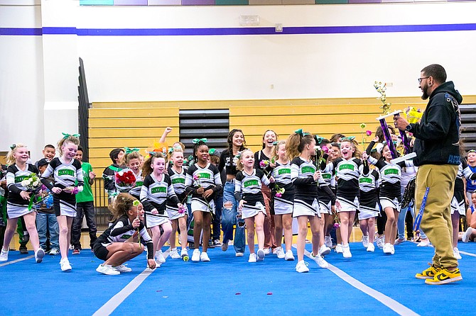 The Fallon freshmen cheer squad accepts the first-place trophy at the recent SYFL cheer competition.