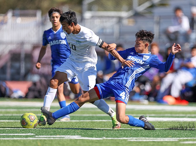 Carson high junior defender, Josue Gomez, slides to take the ball off the foot of a North Valleys attacker in early October. Gomez earned first team all-region honors for his defensive performance this fall.